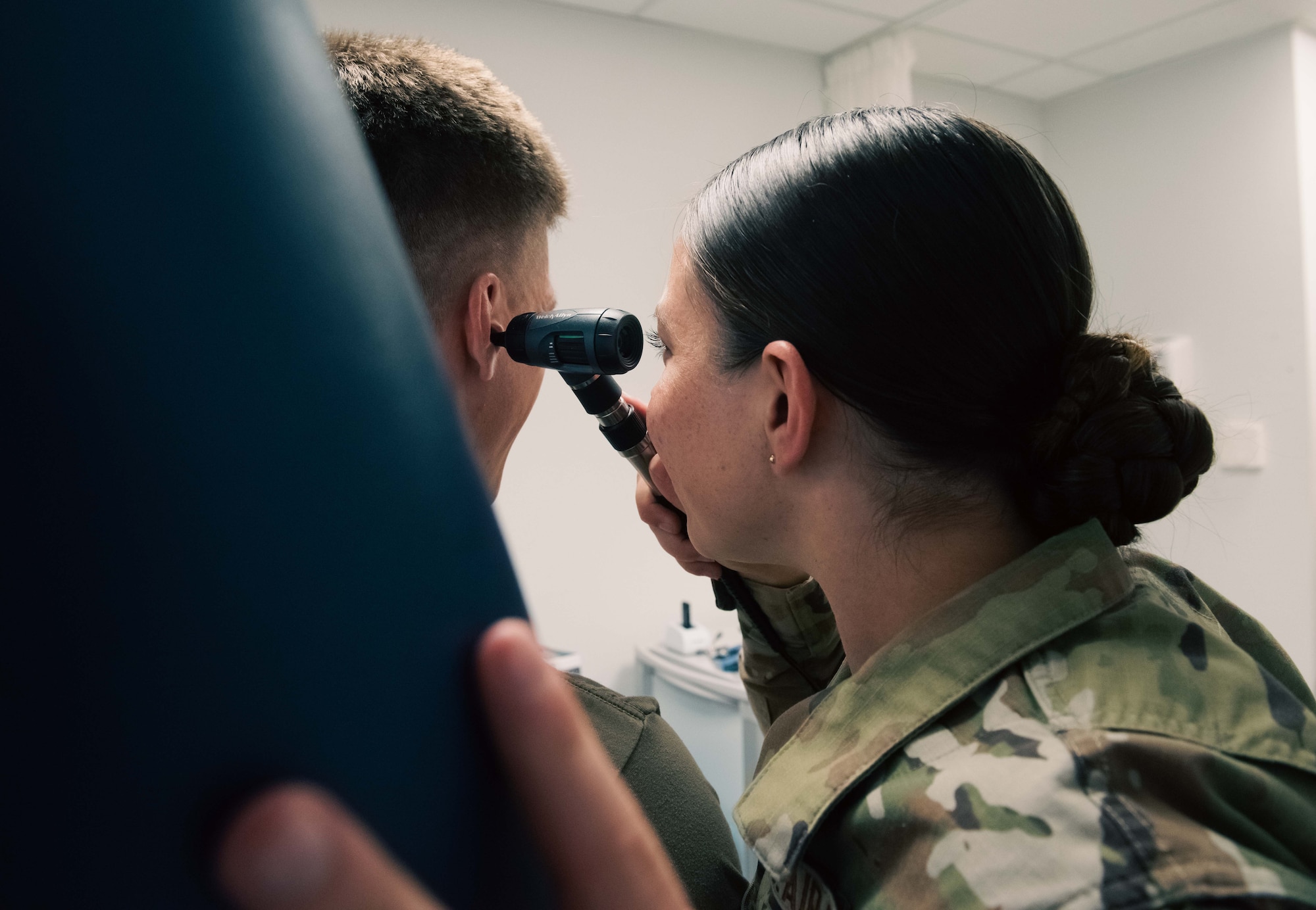 U.S. Airman 1st Class Ashley Polk, 86th Operational Medical Readiness Squadron warrior medicine medical technician, performs an ear inspection at Ramstein Air Base, Germany, June 2, 2025. As part of routine training, Polk practiced critical skills to maintain job knowledge retention to ensure base personnel readiness. (U.S. Air Force photo by Senior Airman Sabrina Fuller-Judd)