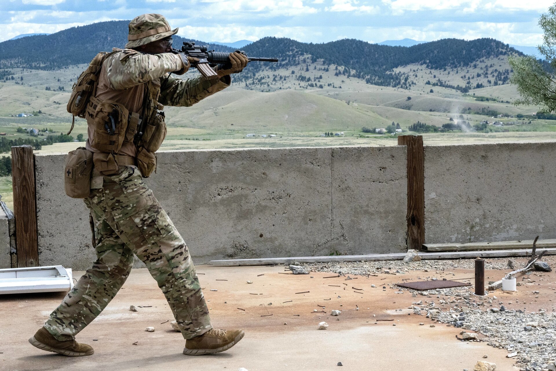 A Security Forces Airman clears an area during a field training exercise at Ft. William Henry Harrison, Helena, Mont., June 4, 2025. Security Forces Squadrons from Arizona and Pennsylvania traveled to the Fort for a week of field training. The field instruction consisted of patrol movements, base security, key leader engagements, chemical, biological, radiological, nuclear and explosives detection response, and simulated attacks from opposition forces. (U.S. Air National Guard photo by Master Sgt. Michael Matkin)