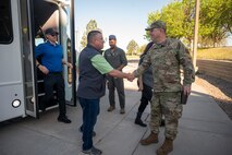 Civilian shakes hands with Airman