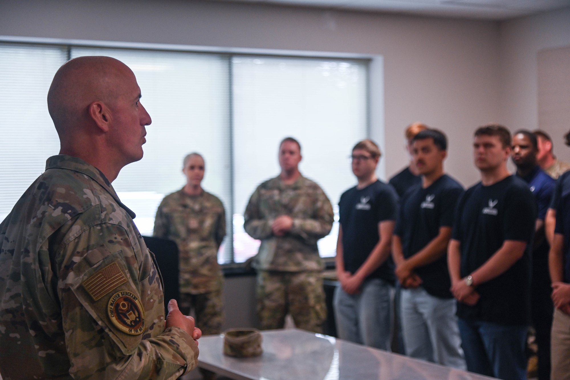 A service member speaks to students.