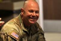 Master Sgt. Francis Sarnecki shares a laugh during remarks from Lt. Col. Allison Jacobs.
