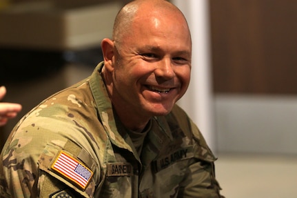 Master Sgt. Francis Sarnecki shares a laugh during remarks from Lt. Col. Allison Jacobs.