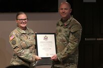Lt. Col. Allison Jacobs, commander of the 634th Brigade Support Battalion, presents Master Sgt. Francis Sarnecki with a certificate of retirement.