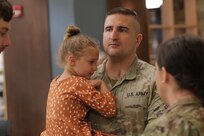 Soldiers with the Illinois Army National Guard’s 232nd Combat Sustainment Support Battalion share heartfelt moments with family and loved ones following a mobilization ceremony