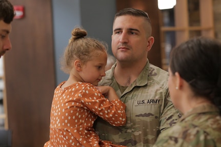 Soldiers with the Illinois Army National Guard’s 232nd Combat Sustainment Support Battalion share heartfelt moments with family and loved ones following a mobilization ceremony