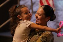 Capt. Alissa Mendez holds her 5-year-old niece, Kamila Mendez, after the Illinois Army National Guard’s 232nd Combat Sustainment Support Battalion mobilization ceremony