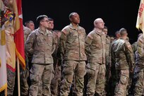 Spc. Quentin Estrada, Spc. Kameron Wilson, and Capt. Justin Torres of the Illinois Army National Guard’s 232nd Combat Sustainment Support Battalion stand in formation during their mobilization ceremony