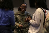 Capt. Madonna Coleman talks to family following the 232nd Combat Sustainment Support Battalion's mobilization ceremony