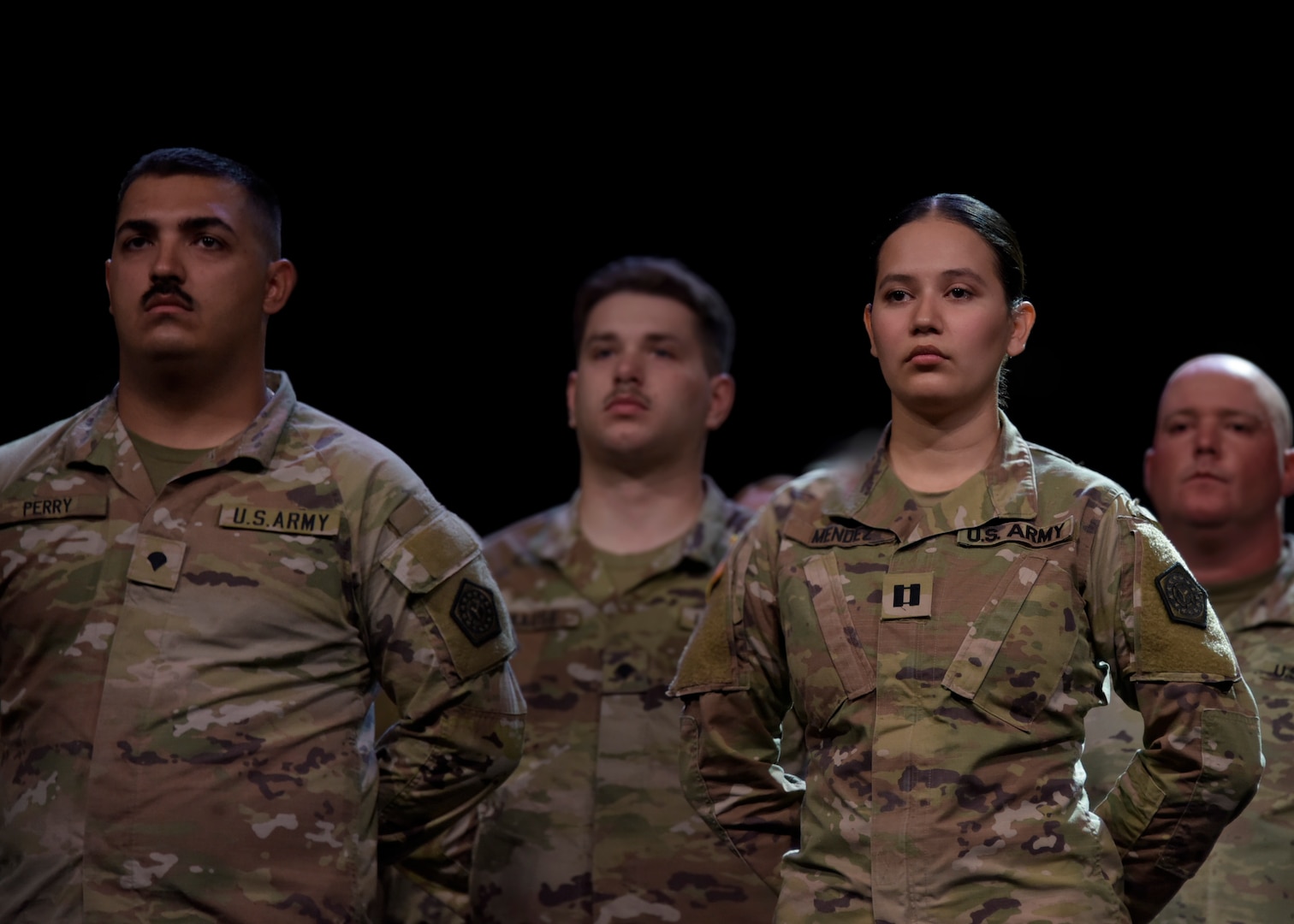 Capt. Alissa Mendez and Spc. Ethan Perry stand in formation during the Illinois Army National Guard’s 232nd Combat Sustainment Support Battalion mobilization ceremony June 7