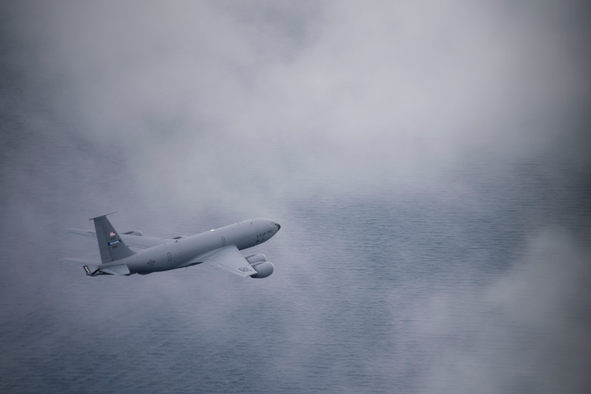 A KC-135R Stratotanker flies through clouds