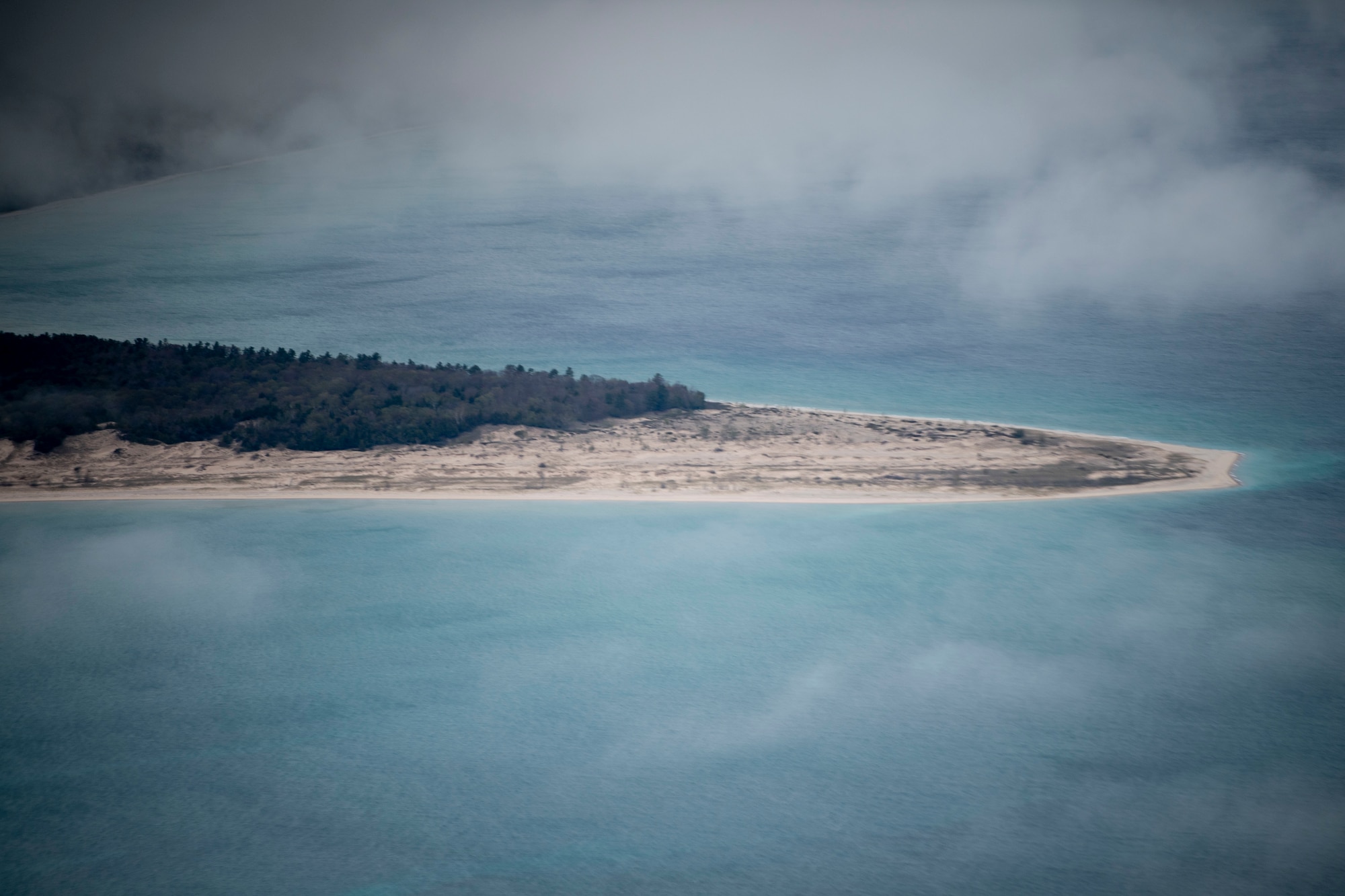 A small peninsula along Michigan's west coast in view through the clouds from a KC-135R