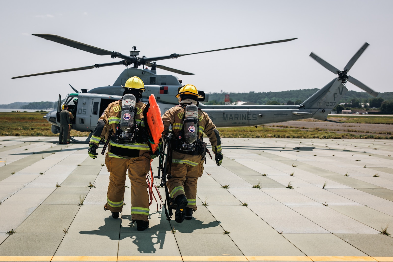 U.S. Marines with Marine Corps Air Facility Quantico approach an AH-1Z Viper attack helicopter for a helicopter medical evacuation exercise at MCAF Quantico on Marine Corps Base Quantico, Virginia, June 4, 2025. Marines conducts training consisting of loading and unloading ordnance and helicopter medical evacuations to increase mission readiness in the event of an emergency. (U.S. Marine Corps photo by Lance Cpl. Braydon Rogers)
