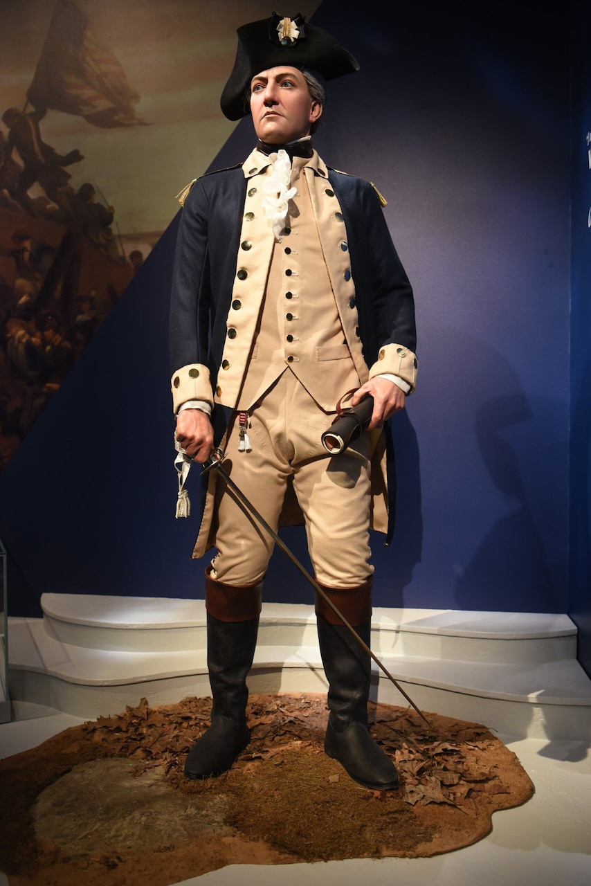 A mannequin in a Continental Army uniform is shown standing while on display in a museum.