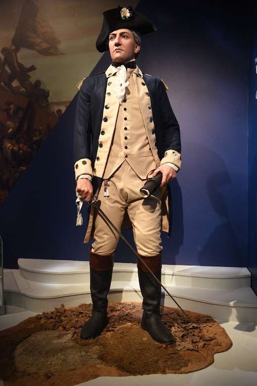 A mannequin in a Continental Army uniform is shown standing while on display in a museum.