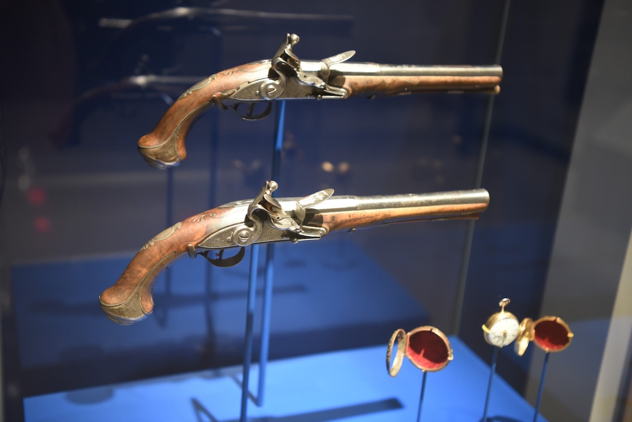 Two Revolutionary War pistols are displayed at a museum.