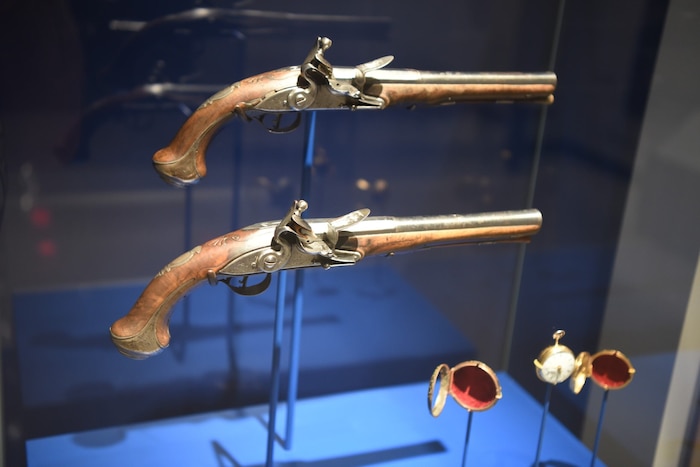 Two Revolutionary War pistols are displayed at a museum.
