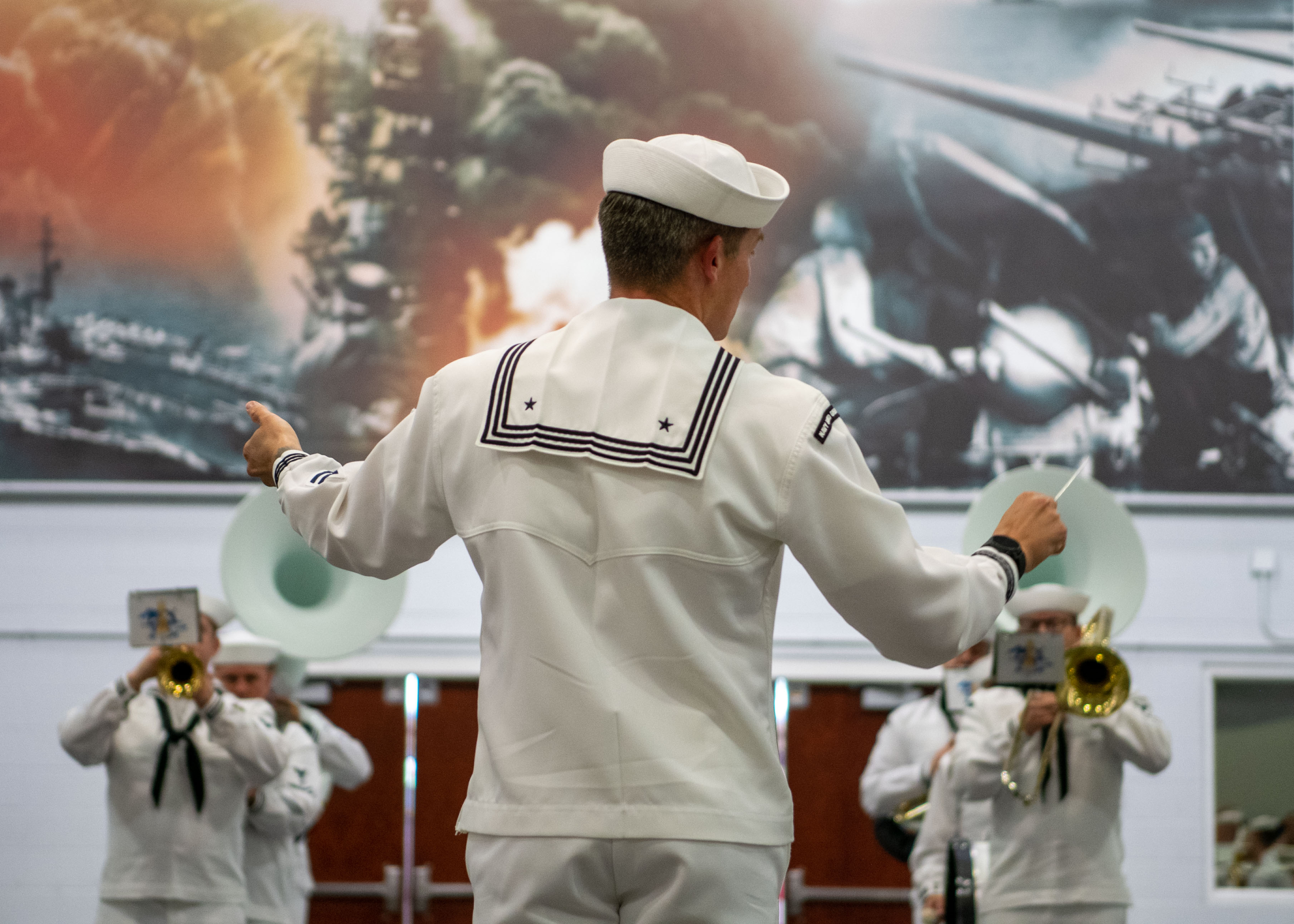 250605-N-GU344-1057 GREAT LAKES, Ill. (June 5, 2025) – Musician 1st Class Patrick Pedlar conducts Navy Band Great Lakes before the start of pass-in-review onboard U.S. Navy Recruit Training Command in Great Lakes, June 5, 2025. Boot camp is approximately nine weeks and all enlistees into the U.S. Navy begin their career at the command. More than 40,000 recruits train annually at the Navy's only boot camp. (U.S. Navy photo by Mass Communication Specialist 1st Class John Suits)