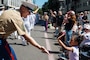 PORTLAND, OREGON (June 7, 2025) – U.S. Marine Corps 1st Sgt. Lloyd Crabtree, the senior enlisted leader for First Intelligence Battalion, I Marine Expeditionary Force Information Group, and a native of California, interacts with Portland natives at the Grand Floral Parade during Portland Fleet Week, June 7, 2025. Portland Fleet Week is a time-honored celebration of the sea services and provides an opportunity for the citizens of Oregon to meet Sailors, Marines, and Coast Guardsmen, as well as witness firsthand the latest capabilities of today’s maritime services. (U.S. Marine Corps photo by Sgt. Amelia Kang)