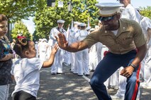 U.S. Marine Corps Capt. Roman Zepeda, the commanding officer for Battlespace Surveillance Company, First Intelligence Battalion, I Marine Expeditionary Force Information Group, and a native of Texas, interacts with Portland natives at the Grand Floral Parade during Portland Fleet Week, June 7, 2025. Portland Fleet Week is a time-honored celebration of the sea services and provides an opportunity for the citizens of Oregon to meet Sailors, Marines, and Coast Guardsmen, as well as witness firsthand the latest capabilities of today’s maritime services. (U.S. Marine Corps photo by Sgt. Amelia Kang)