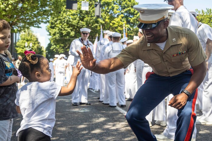 U.S. Marine Corps Capt. Roman Zepeda, the commanding officer for Battlespace Surveillance Company, First Intelligence Battalion, I Marine Expeditionary Force Information Group, and a native of Texas, interacts with Portland natives at the Grand Floral Parade during Portland Fleet Week, June 7, 2025. Portland Fleet Week is a time-honored celebration of the sea services and provides an opportunity for the citizens of Oregon to meet Sailors, Marines, and Coast Guardsmen, as well as witness firsthand the latest capabilities of today’s maritime services. (U.S. Marine Corps photo by Sgt. Amelia Kang)