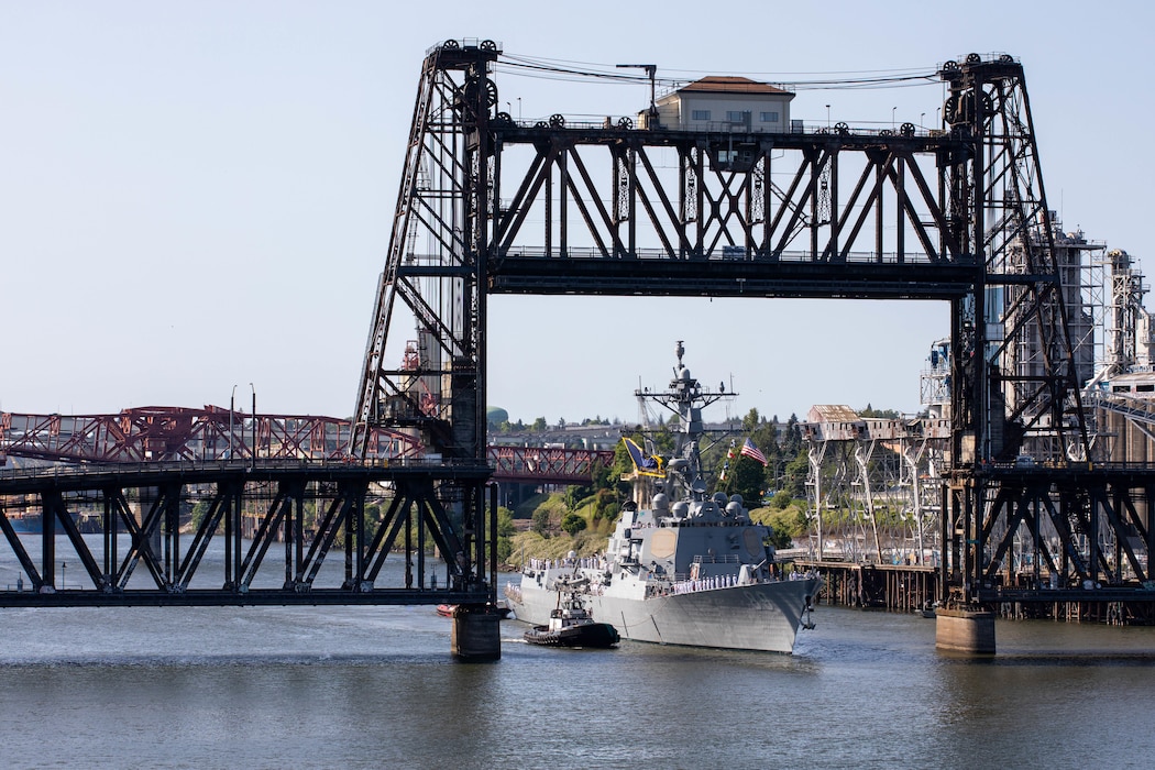 PORTLAND, OREGON (June 3, 2025) – The Arleigh Burke-class guided missile destroyer USS Mustin (DDG 89) sails under the Steel Bridge as it arrives for Portland Fleet Week during the 118th Rose Festival, June 3, 2025. Portland Fleet Week is a time-honored celebration of the sea services and provides an opportunity for the citizens of Oregon to meet Sailors, Marines and Coast Guardsmen, as well as witness firsthand the latest capabilities of today’s maritime services. (U.S. Navy Photo by Mass Communication Specialist 2nd Class John A. Miller)