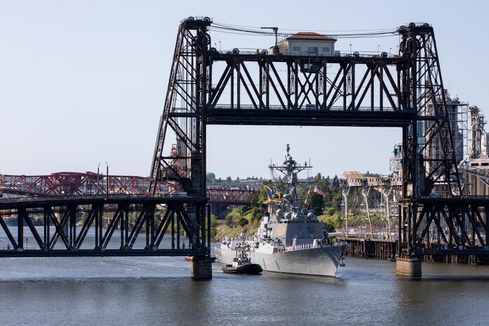 PORTLAND, OREGON (June 3, 2025) – The Arleigh Burke-class guided missile destroyer USS Mustin (DDG 89) sails under the Steel Bridge as it arrives for Portland Fleet Week during the 118th Rose Festival, June 3, 2025. Portland Fleet Week is a time-honored celebration of the sea services and provides an opportunity for the citizens of Oregon to meet Sailors, Marines and Coast Guardsmen, as well as witness firsthand the latest capabilities of today’s maritime services. (U.S. Navy Photo by Mass Communication Specialist 2nd Class John A. Miller)