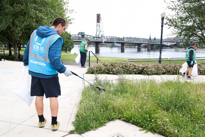 PORTLAND, OREGON (June 5, 2025) – U.S. Navy Sailors pick up trash while volunteering with SOLVE: Stop Oregon Litter and Vandalism during a downtown clean up event at Portland Fleet Week during the 118th Rose Festival, June 5, 2025.  Portland Fleet Week is a time-honored celebration of the sea services and provides an opportunity for the citizens of Oregon to meet Sailors, Marines and Coast Guardsmen, as well as witness firsthand the latest capabilities of today’s maritime services. (U.S. Navy Photo by Mass Communication Specialist 2nd Class Kassandra Alanis)