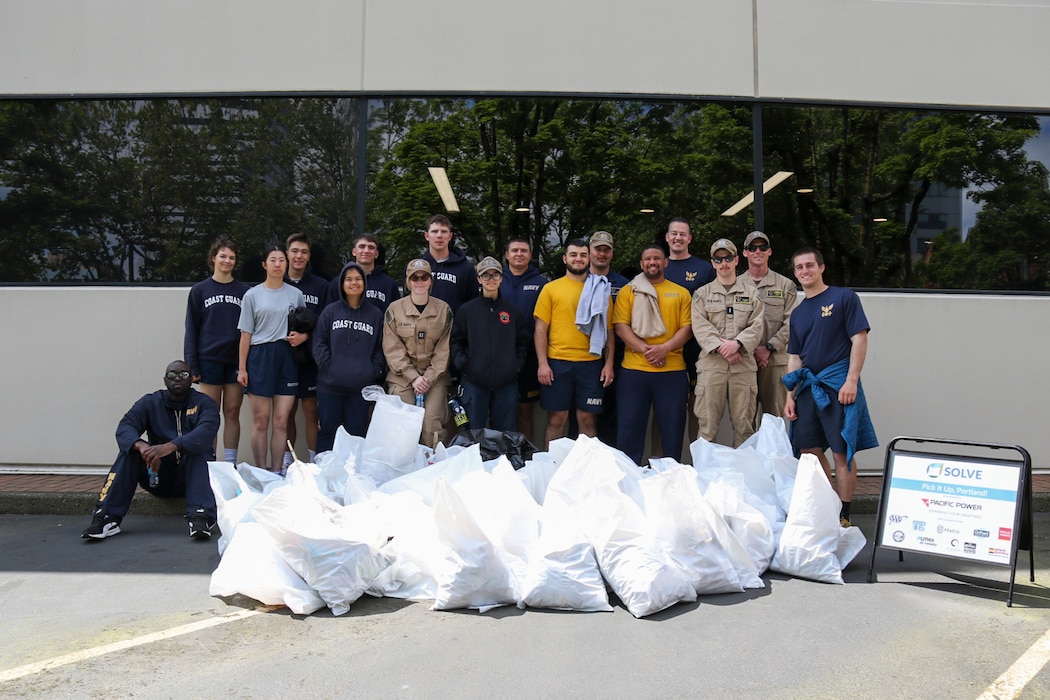 PORTLAND, OREGON (June 5, 2025) – U.S. Navy Sailors pose for a group photo while volunteering with SOLVE: Stop Oregon Litter and Vandalism during a downtown clean up event at Portland Fleet Week during the 118th Rose Festival, June 5, 2025.  Portland Fleet Week is a time-honored celebration of the sea services and provides an opportunity for the citizens of Oregon to meet Sailors, Marines and Coast Guardsmen, as well as witness firsthand the latest capabilities of today’s maritime services. (U.S. Navy Photo by Mass Communication Specialist 2nd Class Kassandra Alanis)