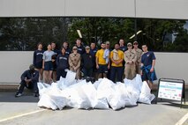 PORTLAND, OREGON (June 5, 2025) – U.S. Navy Sailors pose for a group photo while volunteering with SOLVE: Stop Oregon Litter and Vandalism during a downtown clean up event at Portland Fleet Week during the 118th Rose Festival, June 5, 2025.  Portland Fleet Week is a time-honored celebration of the sea services and provides an opportunity for the citizens of Oregon to meet Sailors, Marines and Coast Guardsmen, as well as witness firsthand the latest capabilities of today’s maritime services. (U.S. Navy Photo by Mass Communication Specialist 2nd Class Kassandra Alanis)