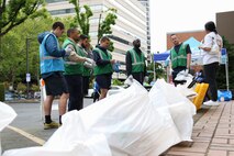 PORTLAND, OREGON (June 5, 2025) – U.S. Navy Sailors pick up trash while volunteering with SOLVE: Stop Oregon Litter and Vandalism during a downtown clean up event at Portland Fleet Week during the 118th Rose Festival, June 5, 2025.  Portland Fleet Week is a time-honored celebration of the sea services and provides an opportunity for the citizens of Oregon to meet Sailors, Marines and Coast Guardsmen, as well as witness firsthand the latest capabilities of today’s maritime services. (U.S. Navy Photo by Mass Communication Specialist 2nd Class Kassandra Alanis)