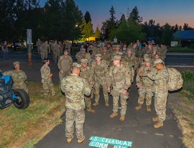 Participants gather at the start line in the pre-dawn light at U.S. Cellular Field in Medford, Ore., June 8, 2025, before beginning the Norwegian Foot March.