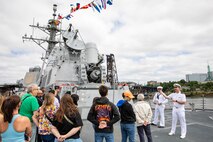 PORTLAND, OREGON (June 5, 2025) – U.S. Navy Ensign David George, right, and Fire Controlman Aegis 2nd Class Dylan Tolleson lead guests on a ship tour aboard the Arleigh Burke-class guided missile destroyer USS Mustin (DDG 89) during Portland Fleet Week, June 5, 2025. Portland Fleet Week is a time-honored celebration of the sea services and provides an opportunity for the citizens of Oregon to meet Sailors, Marines and Coast Guardsmen, as well as witness firsthand the latest capabilities of today’s maritime services. (U.S. Navy Photo by Mass Communication Specialist 2nd Class John A. Miller)