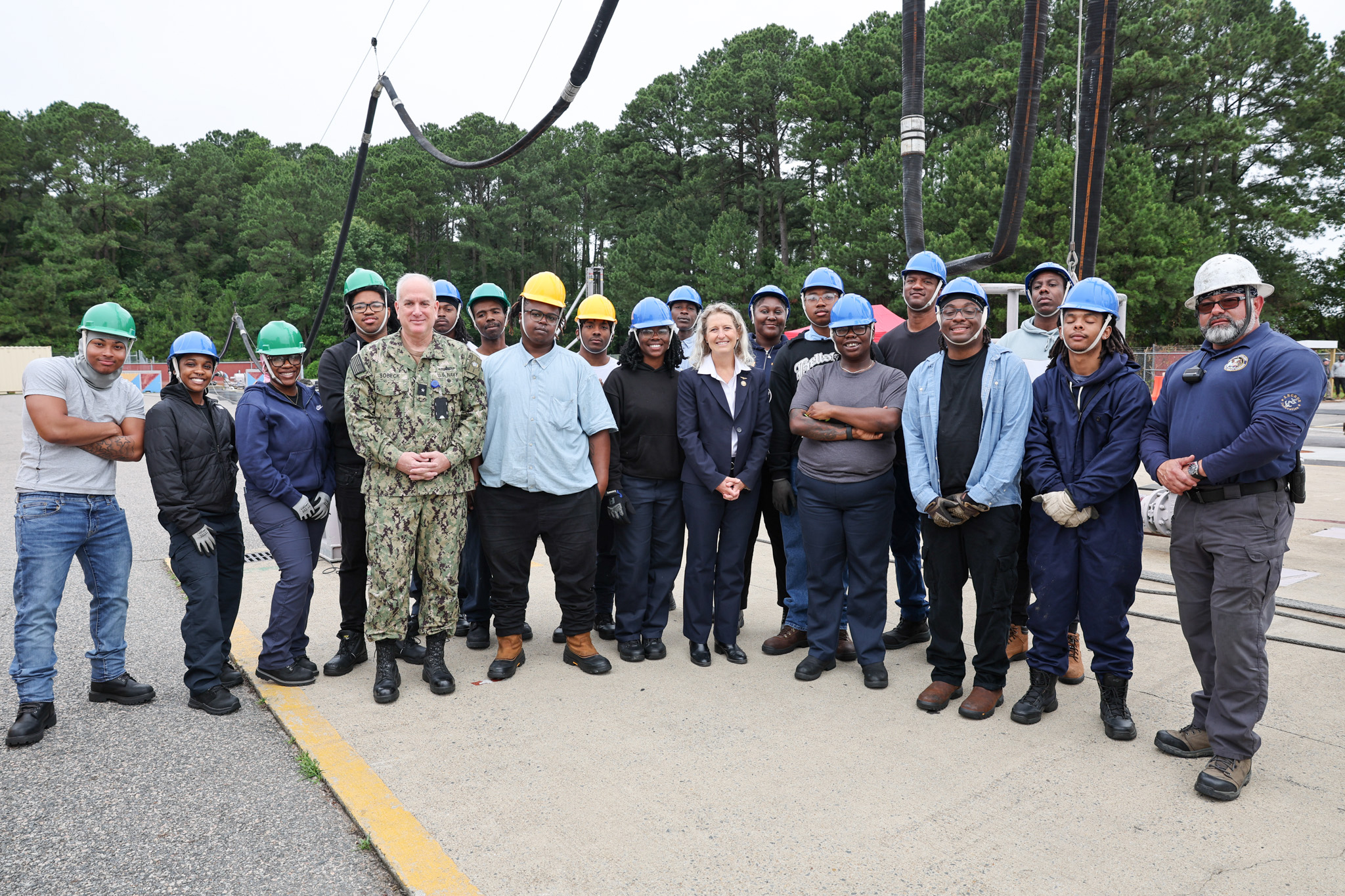 Rep. Jen Kiggans poses with a group of students at Military Sealift Command’s (MSC) Underway Replenishment Center (MUTC), at Joint Expeditionary Base Little Creek in Virginia Beach, Virginia. Kiggans observed the students during an exercise for the Standard Tensioned Replenishment Alongside Method (STREAM) training course, which provides underway replenishment training for more than 600 Civil Service Mariners each year.