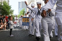 U.S. Navy Sailors march in the Grand Floral Parade during the annual Portland Fleet Week and Rose Festival in Portland, Oregon June 7, 2025. Portland Fleet Week is a time-honored celebration of the sea services and provides an opportunity for the citizens of Oregon to meet Sailors, Marines and Coast Guardsmen, as well as witness firsthand the latest capabilities of today’s maritime services. (U.S. Navy Photo by Mass Communication Specialist 2nd Class Kassandra Alanis)