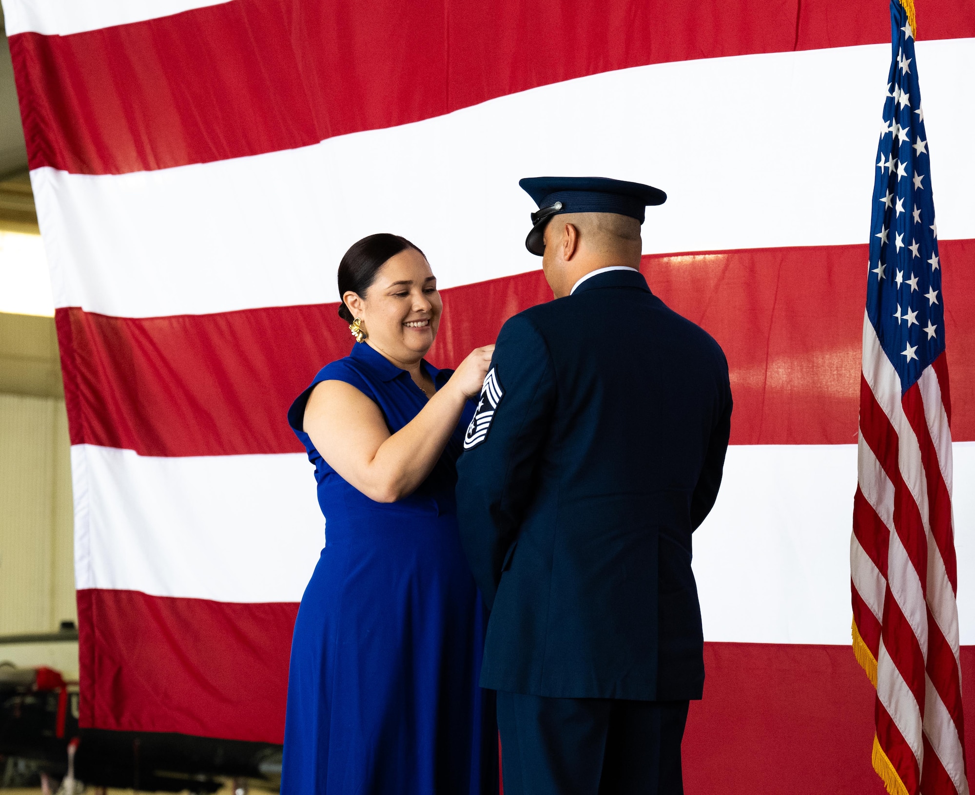 Esmerelda Largaespada, left, pins the retirement pin to the uniform of Chief Master Sgt. Lester Largaespada, right, 47th Flying Training Wing command chief, at Laughlin Air Force Base, Texas, June 6, 2025. The retirement ceremony celebrated the 29 year career of Largaespada. (U.S. Air Force photo by Staff Sgt. Nicholas Larsen)