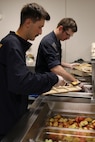 PORTLAND, OREGON (June 7, 2025) – U.S. Navy Boatswain's Mate Gaven Uonites, front, and Electronics Technician 3rd Class Cyrus Vanhoek volunteer during a dinner service at the Burnside Shelter (Portland Rescue Mission) during Portland Fleet Week during the 118th Rose Festival, June 7, 2025. Portland Fleet Week is a time-honored celebration of the sea services and provides an opportunity for the citizens of Oregon to meet Sailors, Marines and Coast Guardsmen, as well as witness firsthand the latest capabilities of today’s maritime services. (U.S. Navy Photo by Mass Communication Specialist 2nd Class Kassandra Alanis)