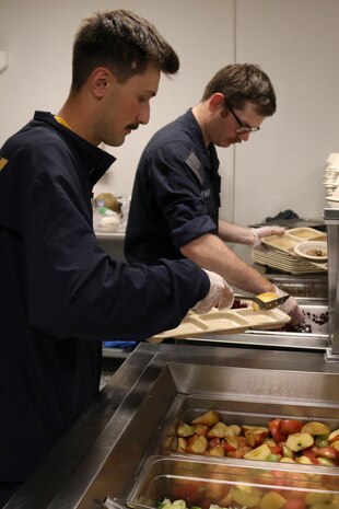 PORTLAND, OREGON (June 7, 2025) – U.S. Navy Boatswain's Mate Gaven Uonites, front, and Electronics Technician 3rd Class Cyrus Vanhoek volunteer during a dinner service at the Burnside Shelter (Portland Rescue Mission) during Portland Fleet Week during the 118th Rose Festival, June 7, 2025. Portland Fleet Week is a time-honored celebration of the sea services and provides an opportunity for the citizens of Oregon to meet Sailors, Marines and Coast Guardsmen, as well as witness firsthand the latest capabilities of today’s maritime services. (U.S. Navy Photo by Mass Communication Specialist 2nd Class Kassandra Alanis)