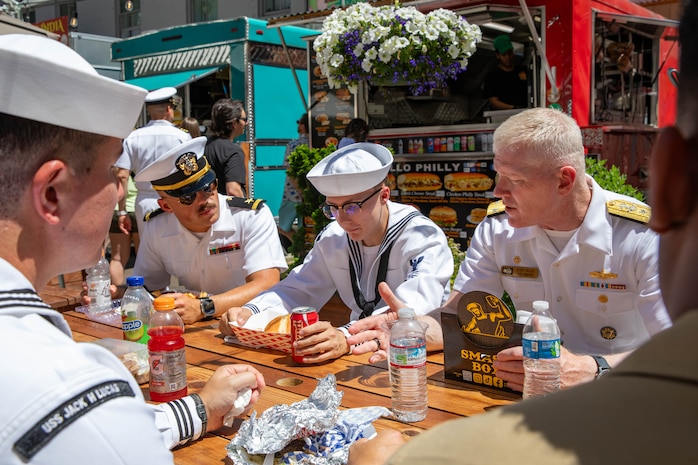 PORTLAND, OREGON (June 7, 2025) – U.S. Navy Vice Adm. John Wade, commander, U.S. 3rd Fleet, right, speaks with Sailors and Marines while having lunch at Midtown Beer Garden during Portland Fleet Week, June 7, 2025. Portland Fleet Week is a time-honored celebration of the sea services and provides an opportunity for the citizens of Oregon to meet Sailors, Marines and Coast Guardsmen, as well as witness firsthand the latest capabilities of today’s maritime services. (U.S. Navy Photo by Mass Communication Specialist 2nd Class John A. Miller)
