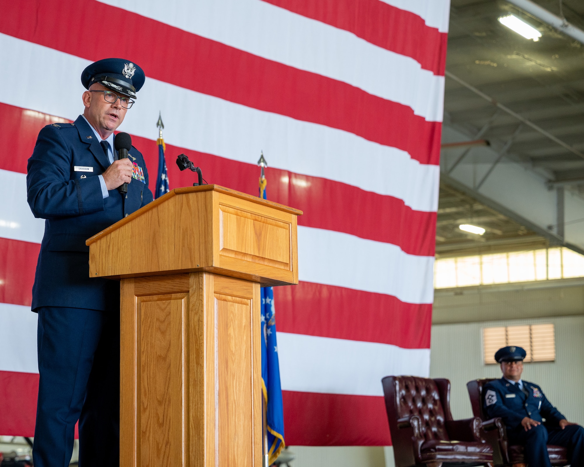 U.S. Air Force Col. Kevin Davidson, left, Africa Command Washington Liaison Office, director, speaks at the retirement ceremony of Chief Master Sgt. Lester Largaespada, right, 47th Flying Training Wing command chief, at Laughlin Air Force Base, Texas, June 6, 2025. The retirement ceremony celebrated the 29 year career of Largaespada. (U.S. Air Force photo by Staff Sgt. Nicholas Larsen)