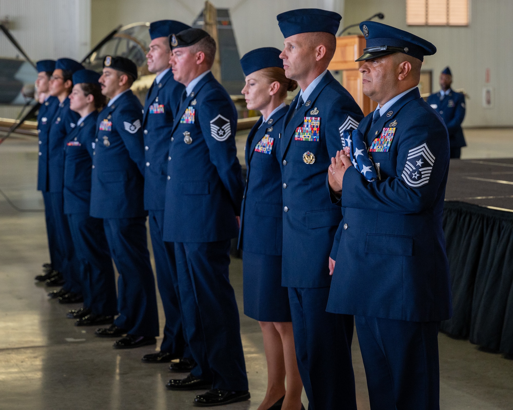 Chief Master Sgt. Lester Largaespada, right, 47th Flying Training Wing command chief, holds the flag presented to him during the flag pass at Laughlin Air Force Base, Texas, June 6, 2025. The retirement ceremony celebrated the 29 year career of Largaespada. (U.S. Air Force photo by Staff Sgt. Nicholas Larsen)
