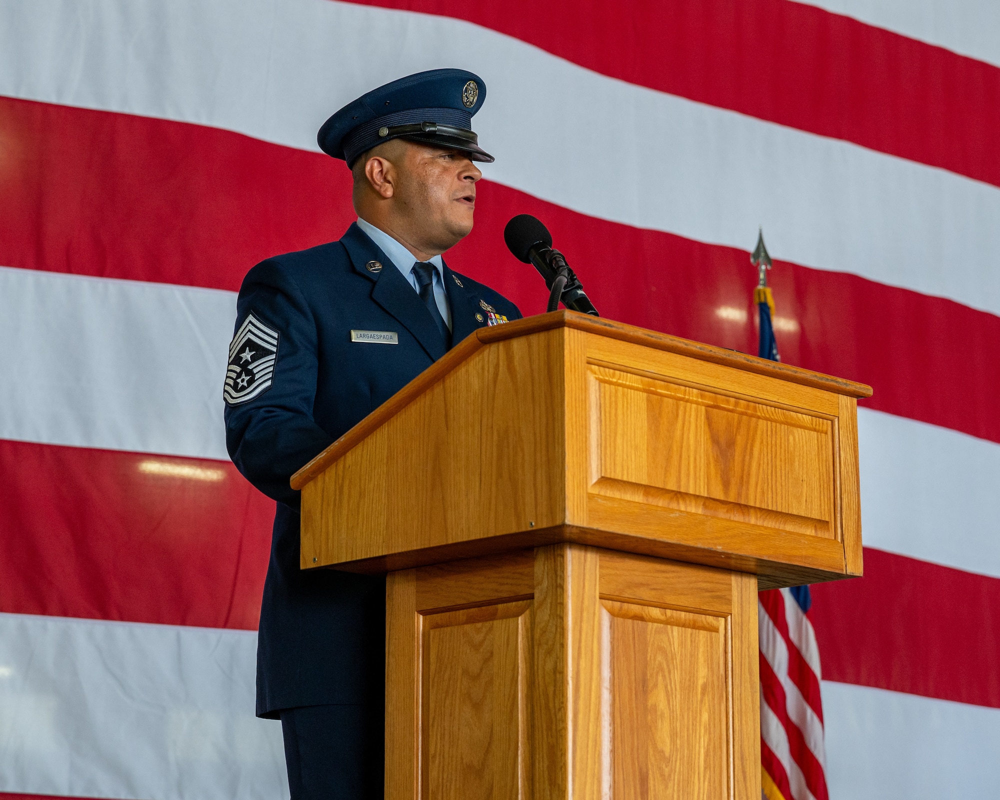 Chief Master Sgt. Lester Largaespada, 47th Flying Training Wing command chief, speaks to the crowd during his retirement ceremony at Laughlin Air Force Base, Texas, June 6, 2025. The retirement ceremony celebrated the 29 year career of Largaespada. (U.S. Air Force photo by Staff Sgt. Nicholas Larsen)