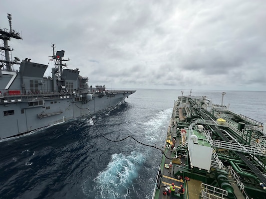 Military Sealift Command’s chartered Motor Tanker Ship Empire State and U.S. Navy amphibious assault ship USS Tripoli (LPH-10) conduct the first Consolidated Replenishment at Sea (CONSOL) between Tripoli and a tanker ship.