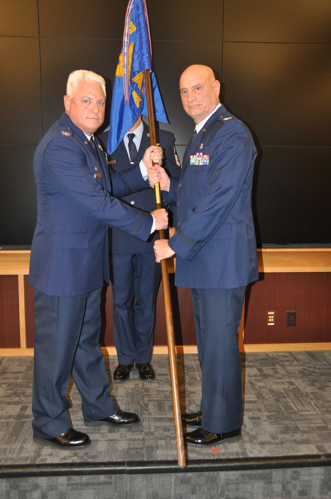 one person hands another a flag