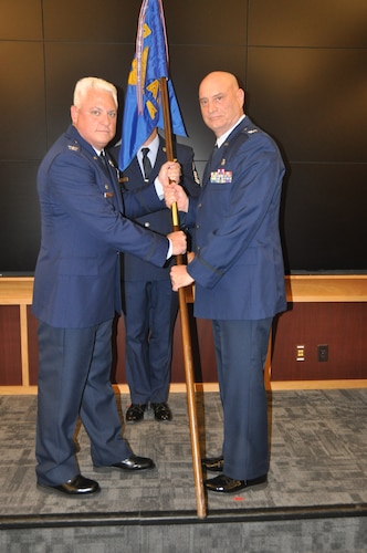 one person hands another a flag