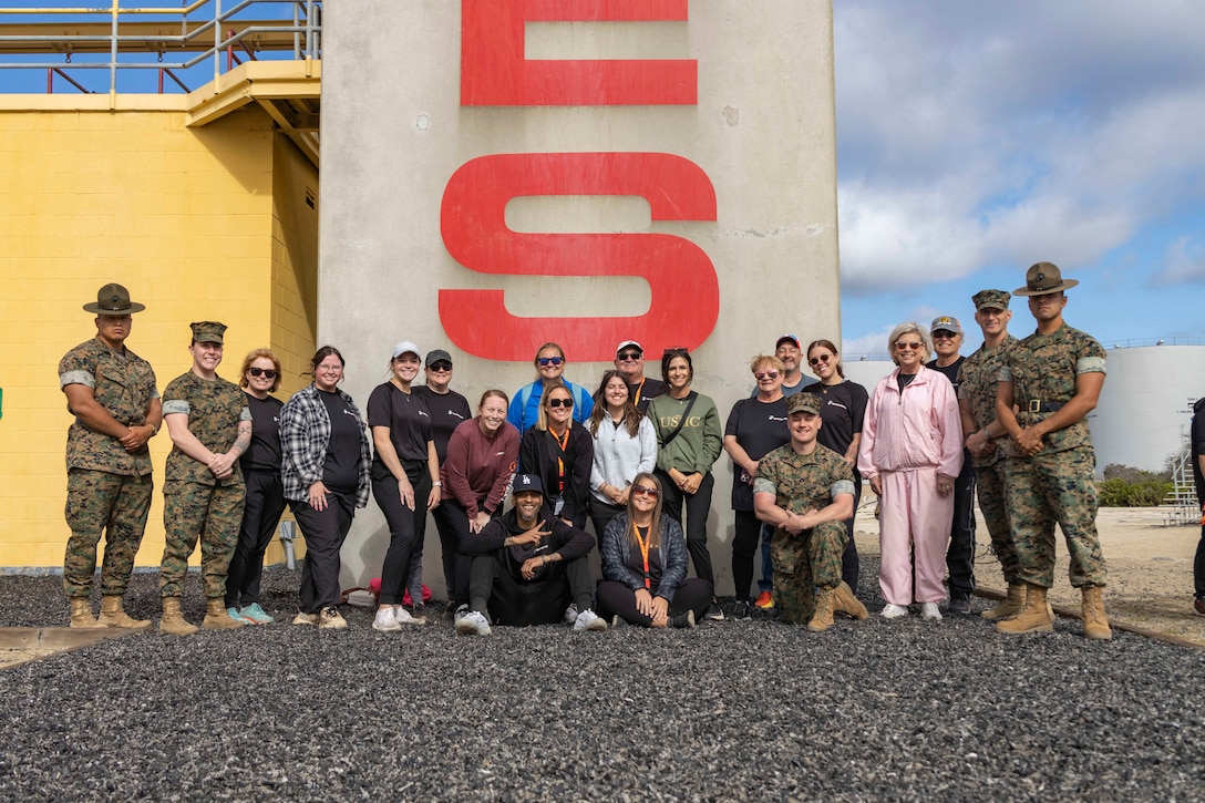 Marines and educators with Recruiting Station Oklahoma City, pose for a group photo during the 2025 Educators Workshop at Marine Corps Recruit Depot San Diego, California, May 1, 2025. The Educators Workshop program provides selected educators and influential community members with an experiential opportunity to see how the Marine Corps transforms young men and women into Marines. Attendees receive current information regarding Marine Corps training practices, military job skills, service opportunities, military lifestyle, and educational benefits available to Marines. (U.S. Marine Corps photo by Staff Sgt. Lennon Dregoiw)