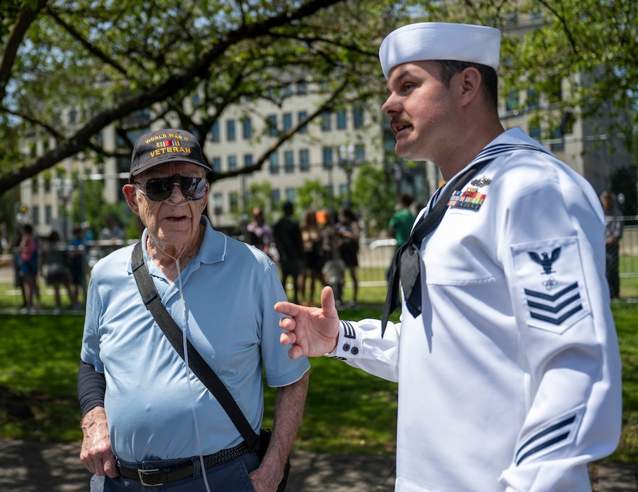 PORTLAND, OREGON (June 6, 2025) – Gil Stahl, World War II veteran, receives a ship tour from Electronics Technician 1st Class Karl Zilz, assigned to the Arleigh Burke-class guided missile destroyer USS Mustin (DDG 89) during the 118th Rose Festival, June 6, 2025. Portland Fleet Week is a time-honored celebration of the sea services and provides an opportunity for the citizens of Oregon to meet Sailors, Marines and Coast Guardsmen, as well as witness firsthand the latest capabilities of today’s maritime services. (U.S. Navy Photo by Mass Communication Specialist Seaman Jordan Steis)