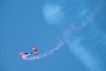Parachutist Cory Christiansen descends with a large American flag in a parachute demonstration to open the Beale Air & Space Expo at Beale Air Force Base, California, June 7, 2025.