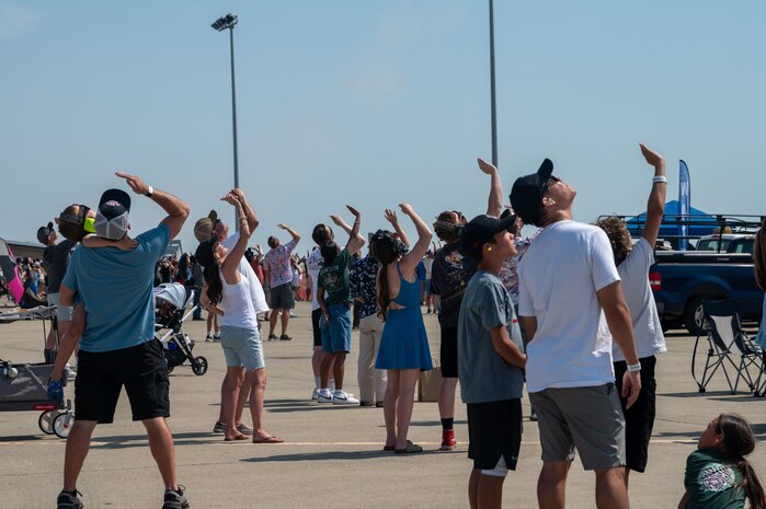 A crowd of people watch aircraft flying during the Beale Air & Space Expo at Beale Air Force Base, California, June 7, 2025.