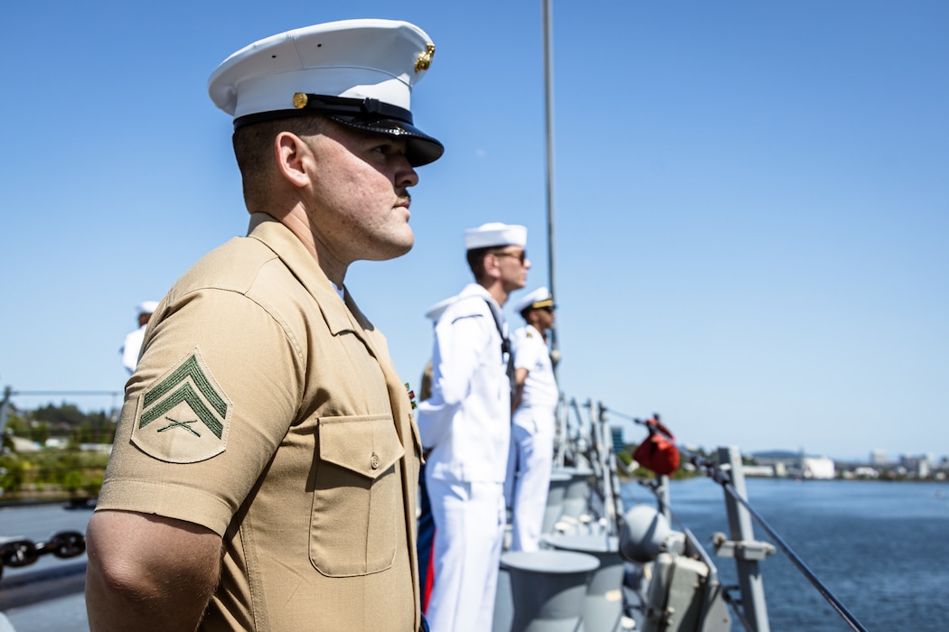PORTLAND, OREGON (June 3, 2025) – U.S. Marine Corps Cpl. Grayson Baggett an infantryman assigned to Battel Space Surveillance Company, 1st Intelligence Battalion, I Marine Expeditionary Force Information Group, and a native of Georgia, mans the rails of the Arleigh Burke-class guided missile destroyer USS Jack H. Lucas (DDG 125) sailing in the Willamette River as it arrives for Portland Fleet Week during the 118th Rose Festival, June 3, 2025. Portland Fleet Week is a time-honored celebration of the sea services and provides an opportunity for the citizens of Oregon to meet Sailors, Marines, and Coast Guardsmen, as well as witness firsthand the latest capabilities of today’s maritime services. (U.S. Marine Corps photo by Cpl. Peyton Kahle)