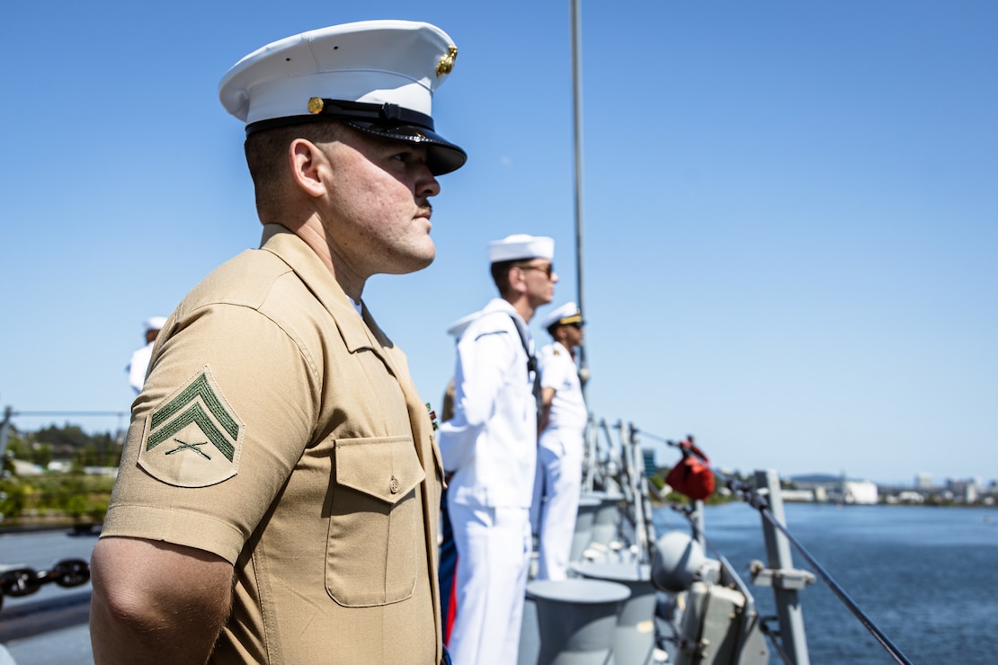 PORTLAND, OREGON (June 3, 2025) – U.S. Marine Corps Cpl. Grayson Baggett an infantryman assigned to Battel Space Surveillance Company, 1st Intelligence Battalion, I Marine Expeditionary Force Information Group, and a native of Georgia, mans the rails of the Arleigh Burke-class guided missile destroyer USS Jack H. Lucas (DDG 125) sailing in the Willamette River as it arrives for Portland Fleet Week during the 118th Rose Festival, June 3, 2025. Portland Fleet Week is a time-honored celebration of the sea services and provides an opportunity for the citizens of Oregon to meet Sailors, Marines, and Coast Guardsmen, as well as witness firsthand the latest capabilities of today’s maritime services. (U.S. Marine Corps photo by Cpl. Peyton Kahle)